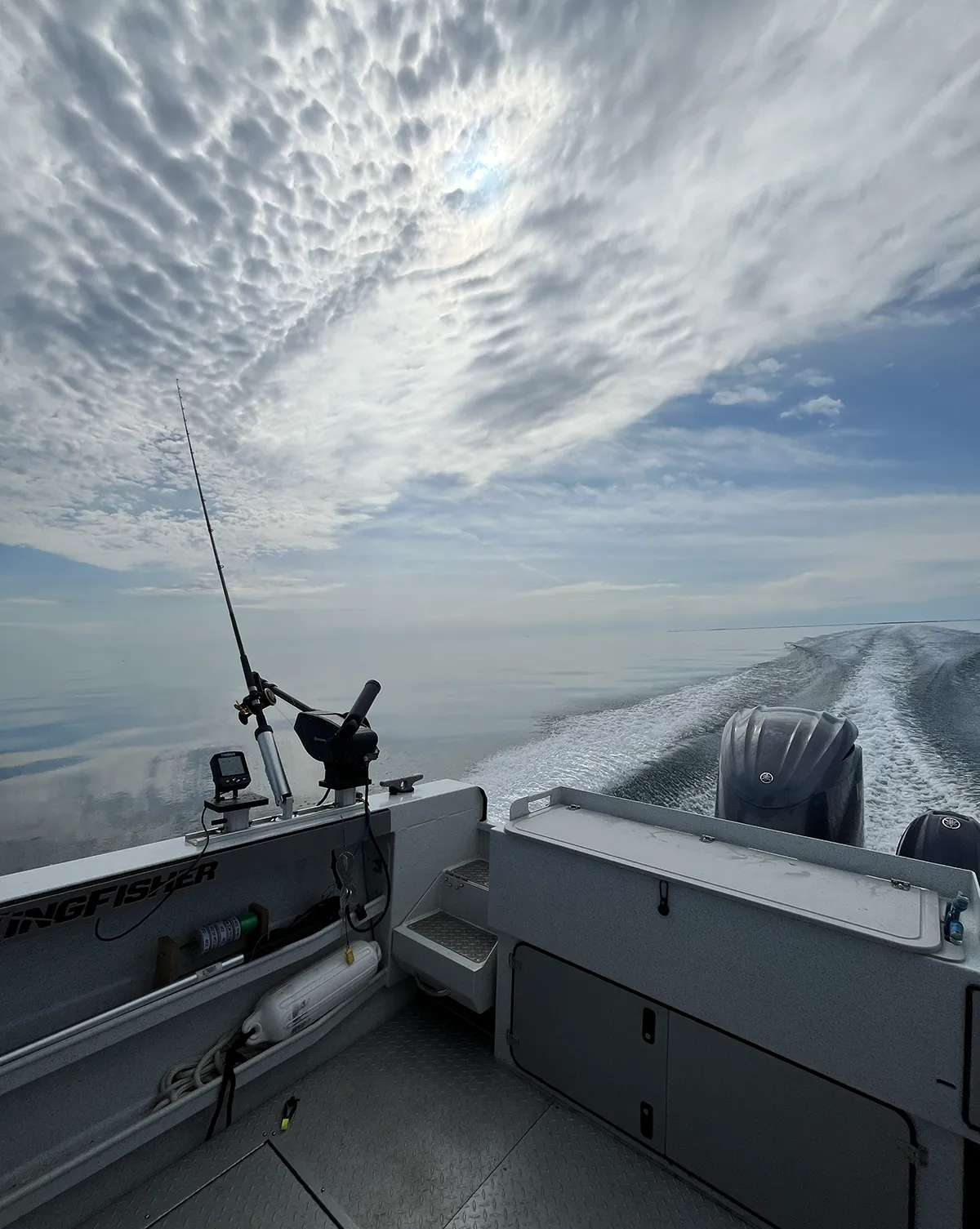 Transom view underway on Lake Ontario with rods, downriggers and Fish Hawk display