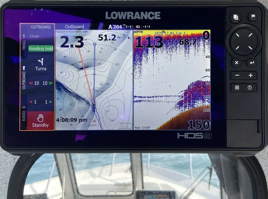 Lowrance HDS Live sonar marking stacked lake trout on a point near Bath, Ontario with two downrigger weights positioned just above the fish